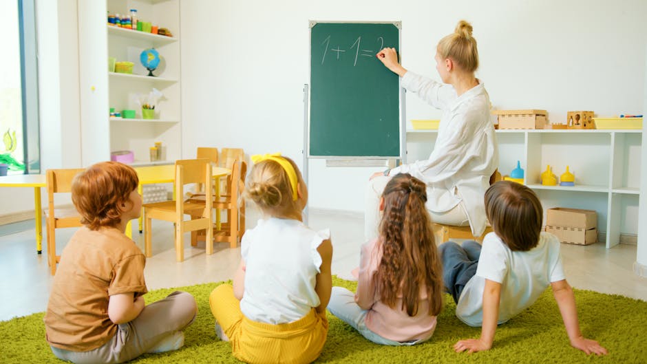 Teacher instructing young students with math on a chalkboard in a bright classroom setting