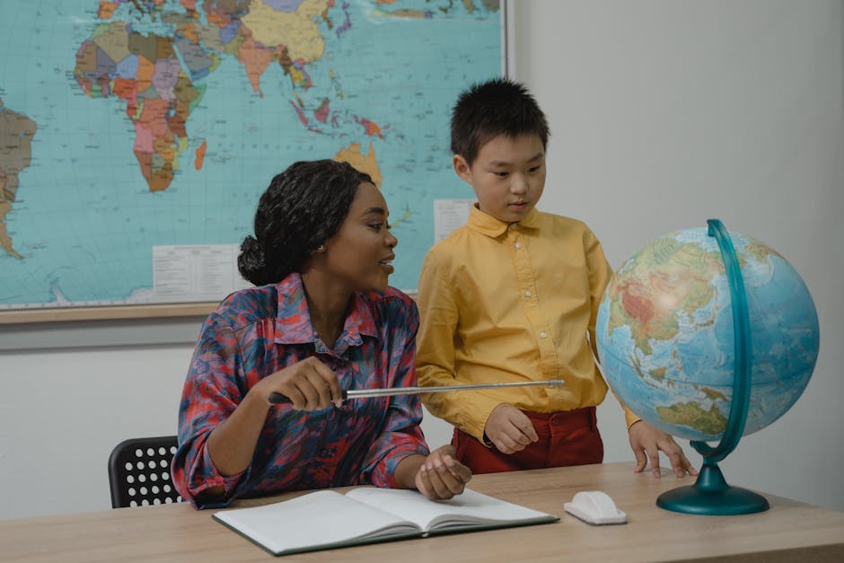 A teacher explaining world geography to a student using a globe in a classroom setting